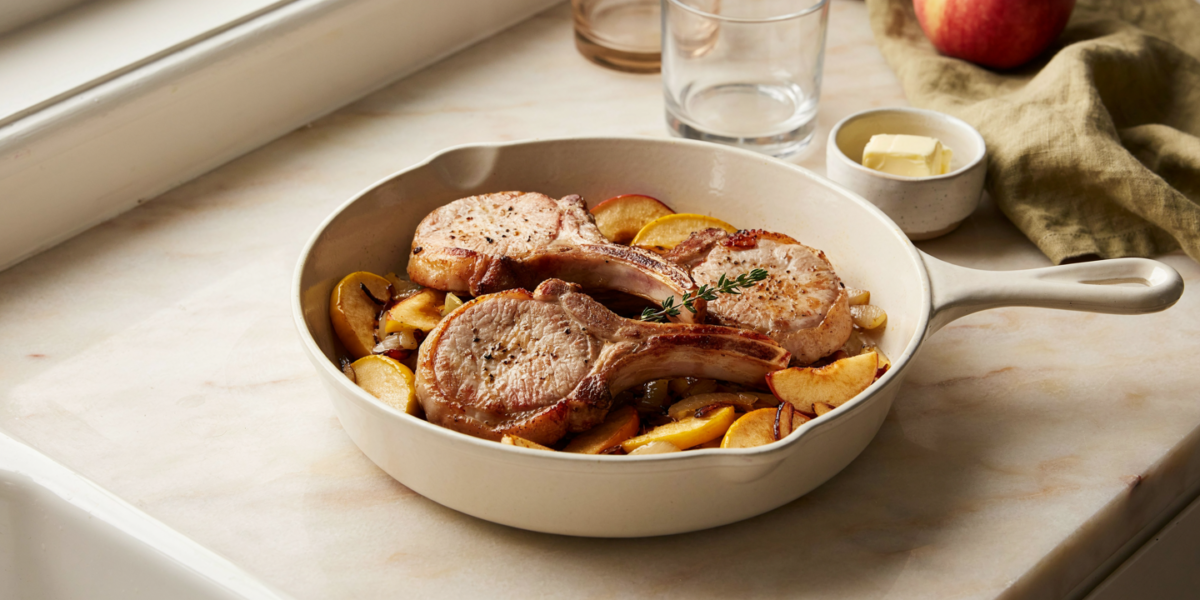 Seared pork chops with caramelized apple and onion slices